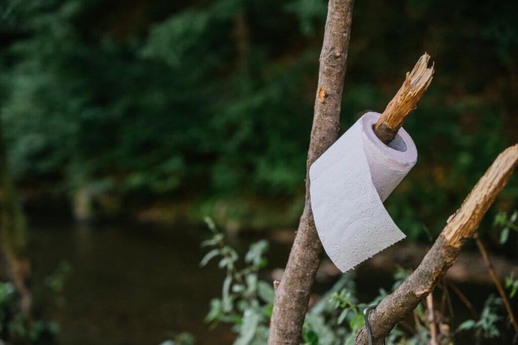 toilet paper hanging on branch out side of a camper van