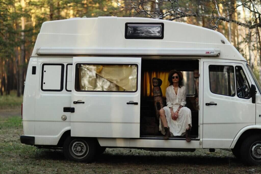 woman sitting on a camper van toilet in her van