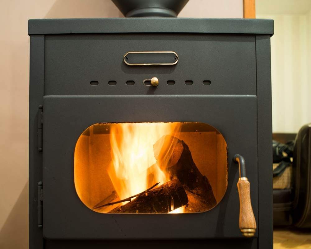a wood stove that is lit for keeping camper van warm