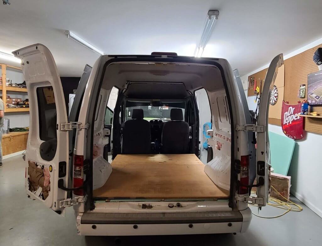 the ply wood on the bottom of the camper van as a subfloor