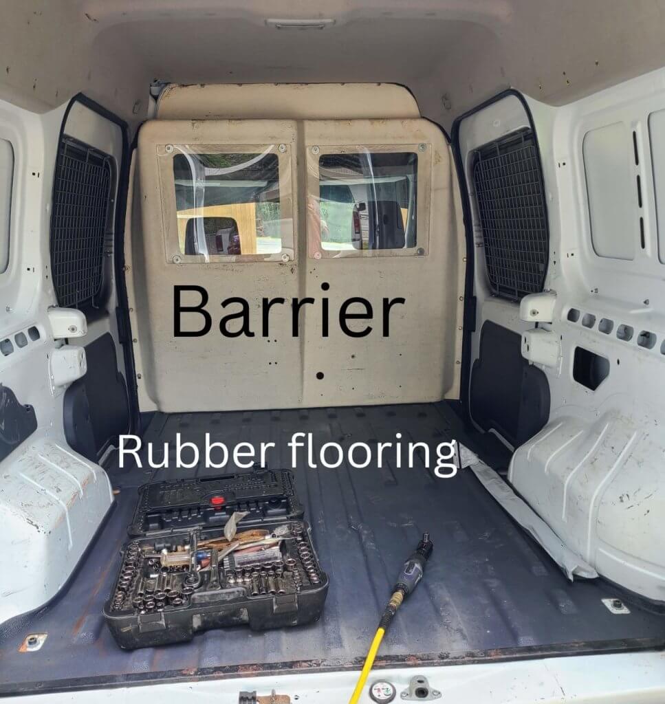 a barrier and rubber flooring material that needs to be torn out of the camper van.