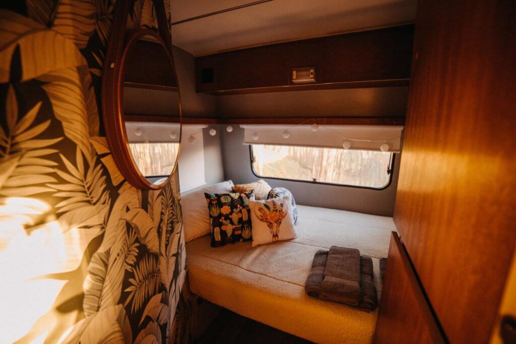 camper van bed option. white bed with cute throw pillows