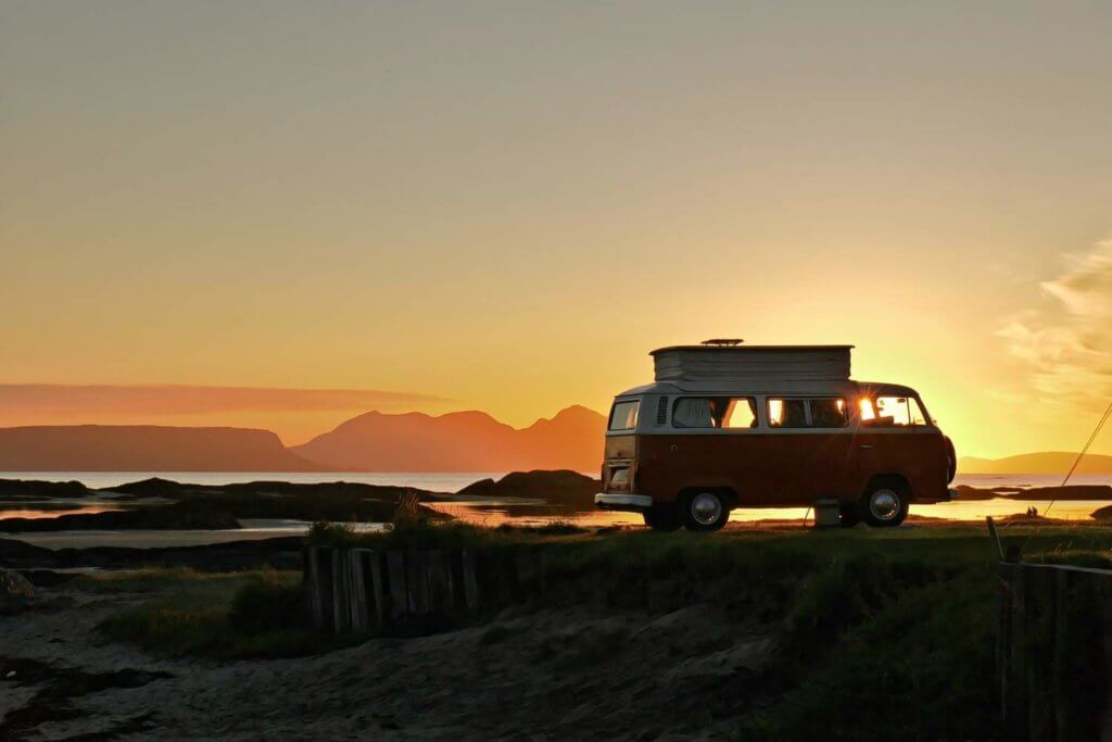 orange camper van in the sunset