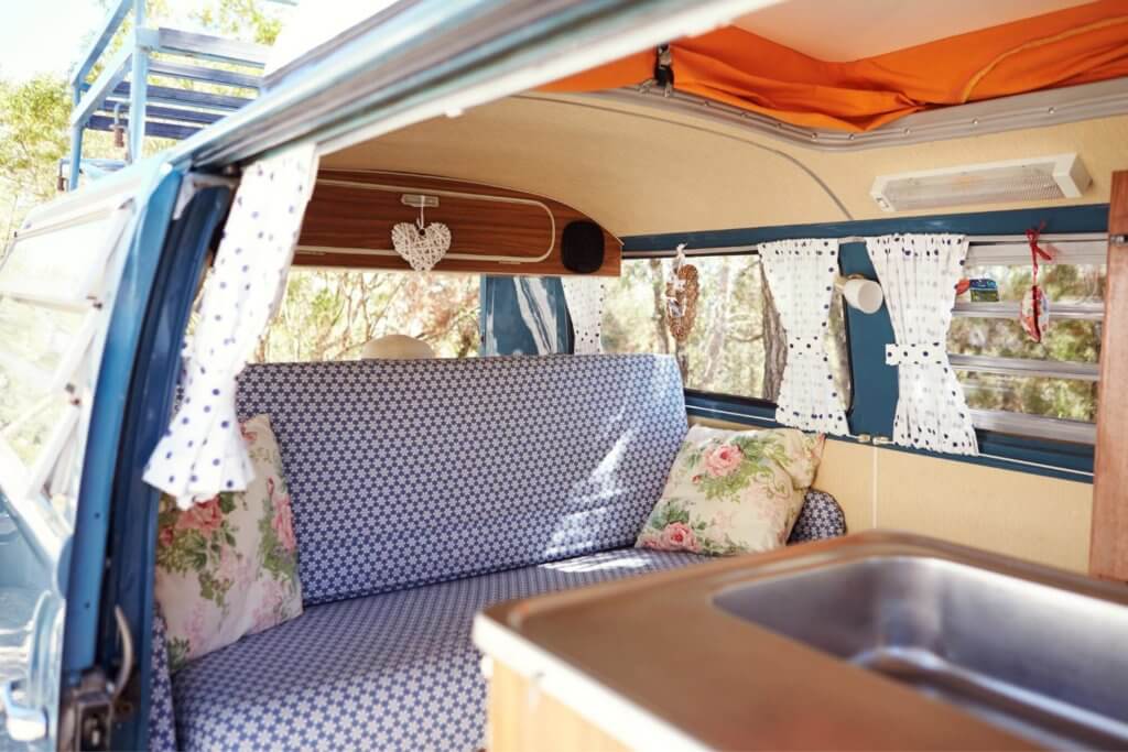 camper van bed layout with kitchen in front of van and bed in back of van