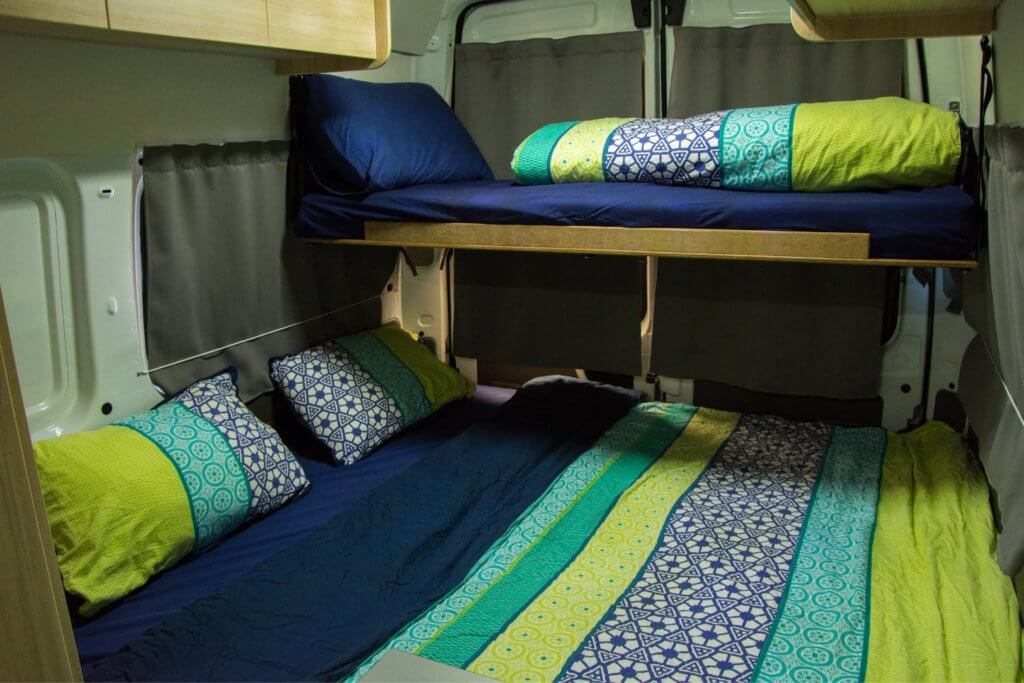 bunk beds for types of camper van bed ideas. Blue and green sheets, one bed is queen size the other is twin
