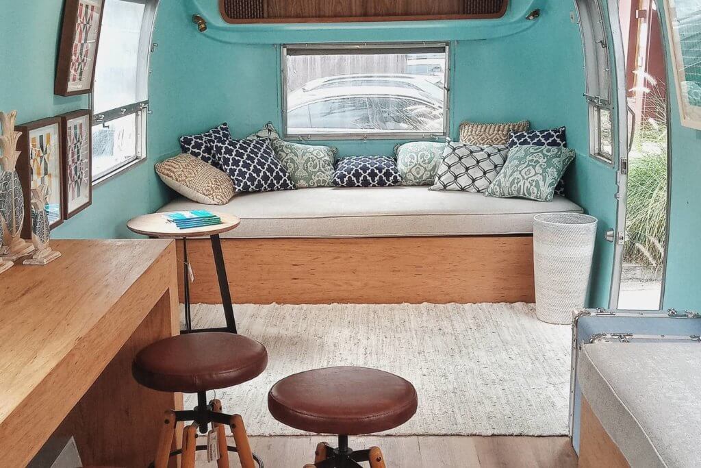 camper van bench bed, pretty blue pillows
