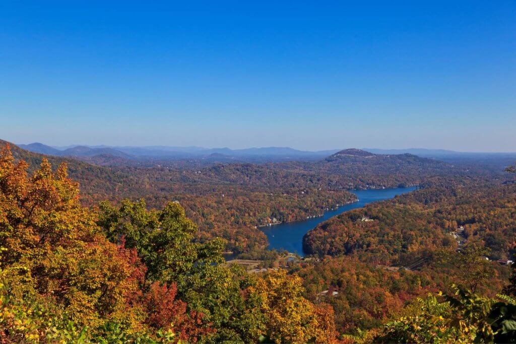 Lake Lure in the fall time. Over head view of lake lure with colorful leaves and trees surrounding.