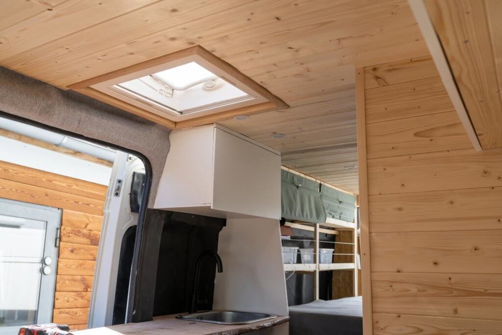 camper van with storage space above the kitchen area