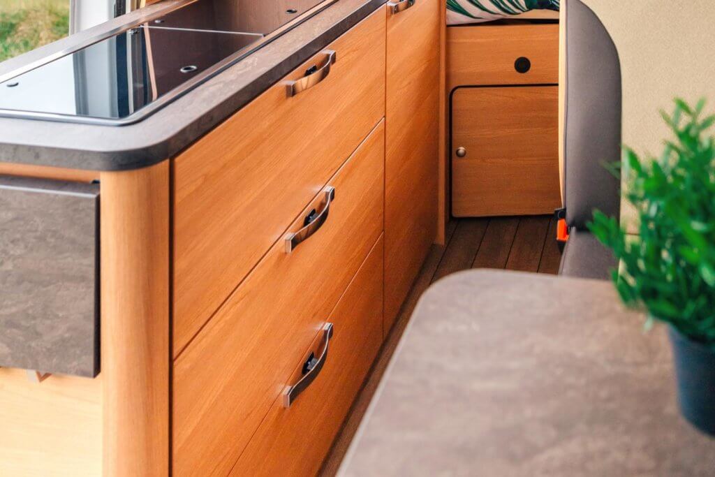 wooden sliding drawers in a camper van kitchen