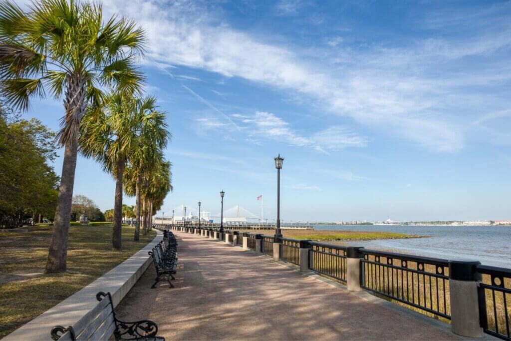 a picture of the waterfront park in Charleston. There is a bay and a bridge off in the distance.