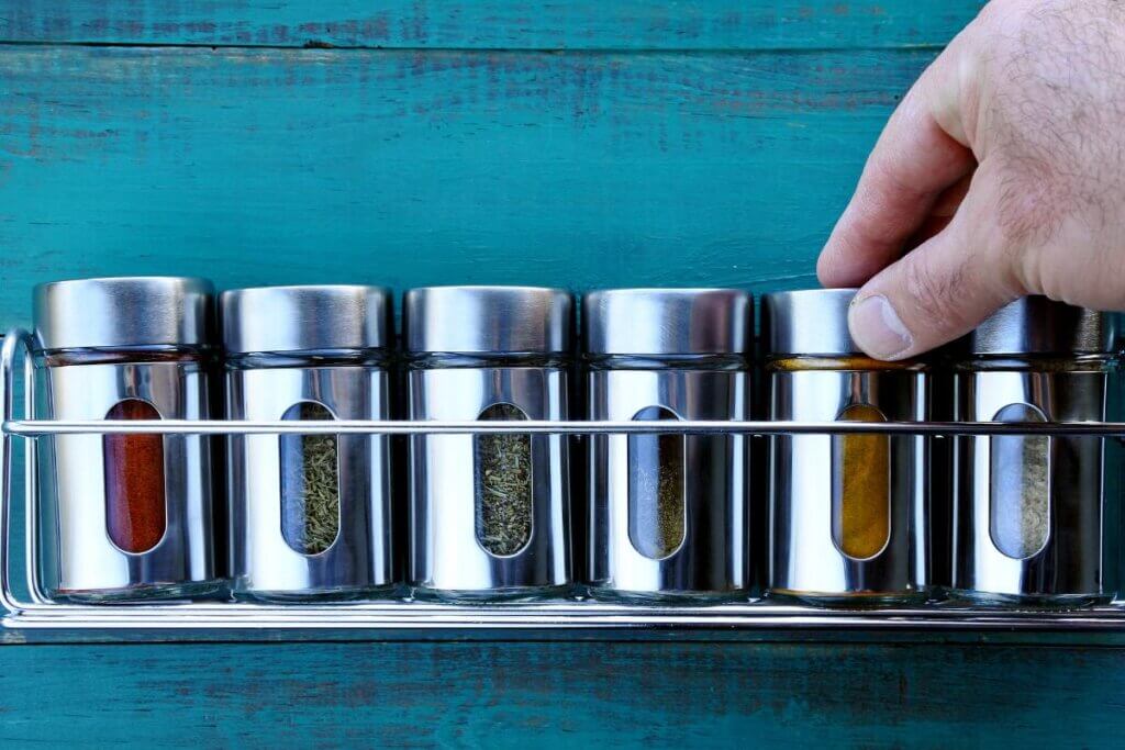 spice rack against a blue wall