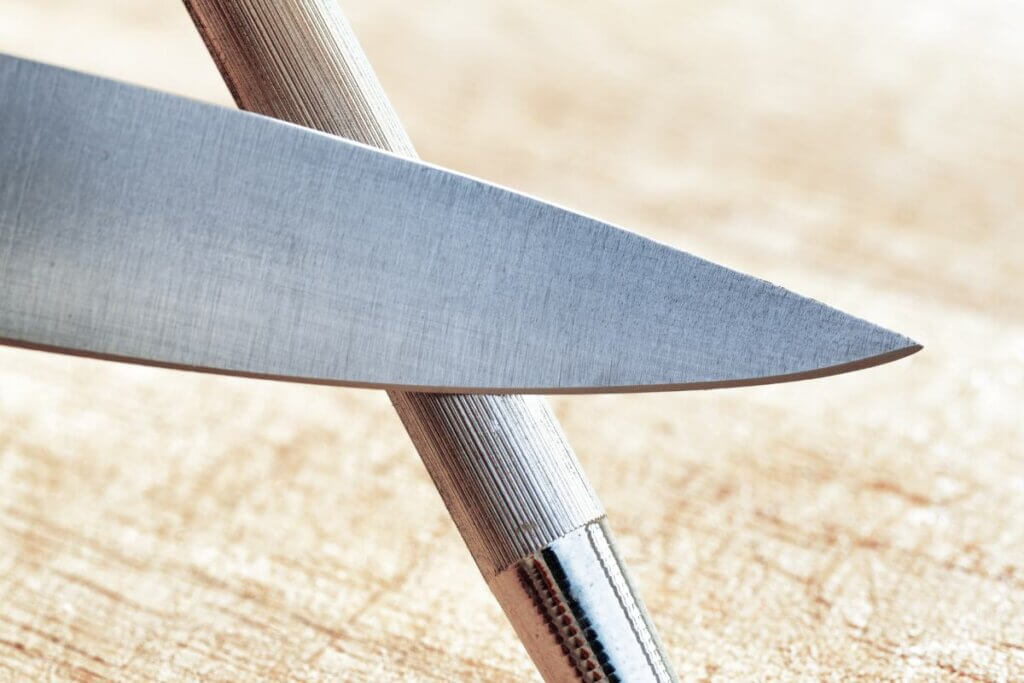 knife held against a knife sharpener