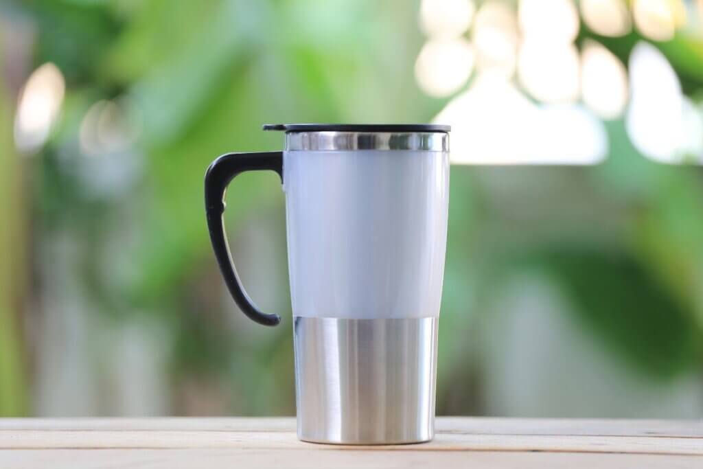 insulated white coffee mug with black handle
