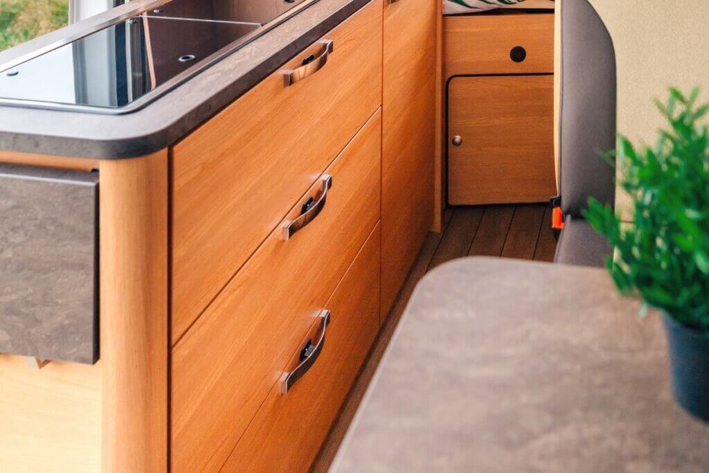 wooden cabinets in a camper van kitchen