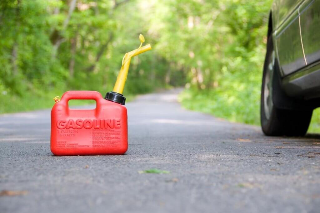 small gas can on the road next to a camper van