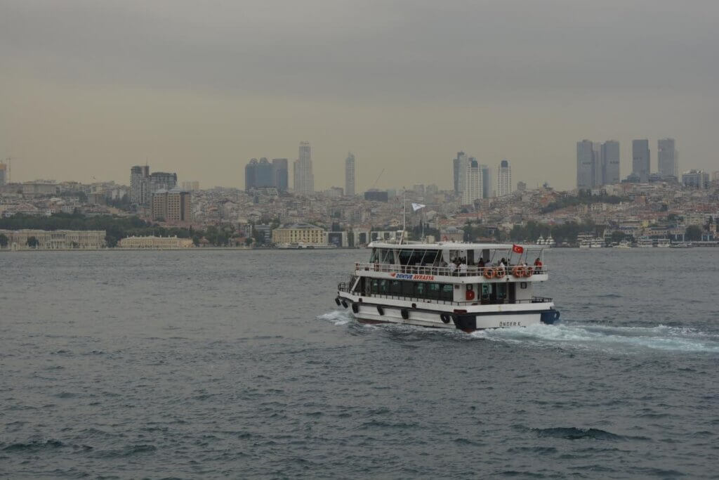 city with a ferry boat in the harbor