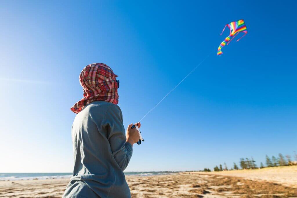 flying a kite when its cold at the beach