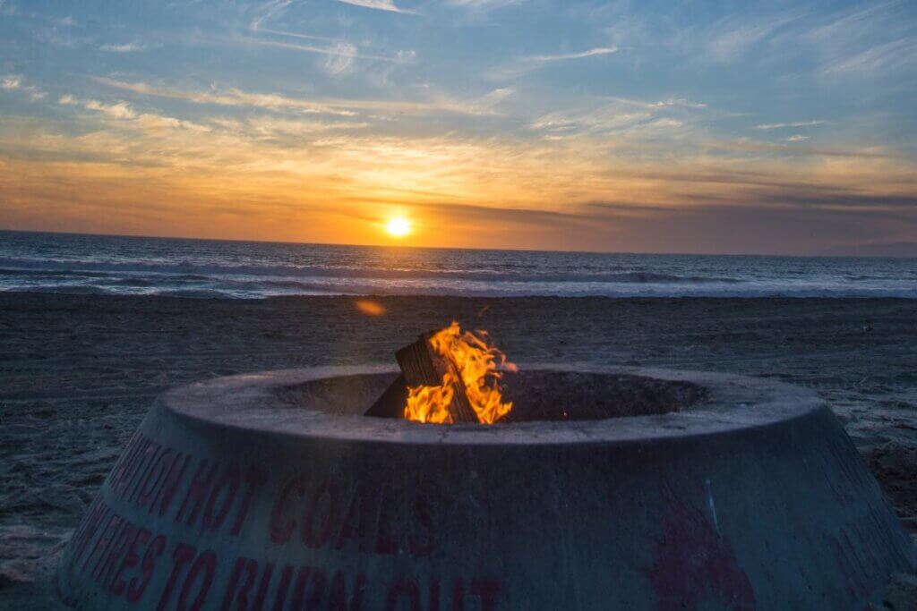 bond fire on the beach at sunset in the winter